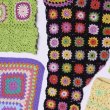 A flat lay of several colourful crocheted items.